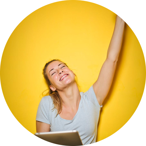 Woman celebrating while using a laptop